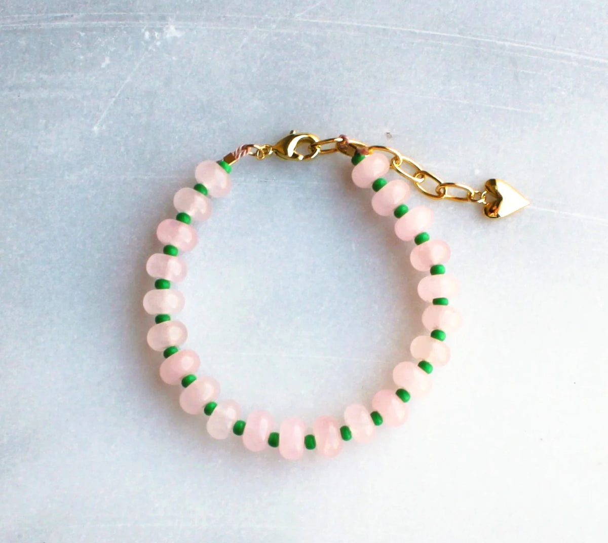 Gorgeous colorful stone candy jade is hand strung to create this beaded bracelet.  Layer these up or wear them alone, they are perfect for a stylish pop of color to your outfits! 
__________________
D E T A I L S

•Colorful jade strung by hand 
•18kt gold filled closure and heart charm
•Available in a 6.5 inch length with a 1.5 inch extender