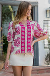 Slight puff sleeve and bold, bright pink pattern 