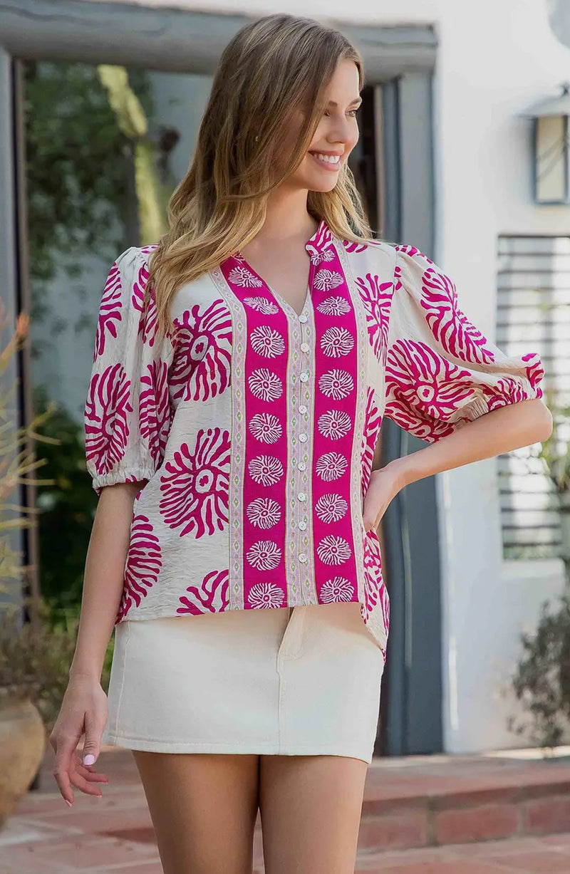 Slight puff sleeve and bold, bright pink pattern 