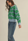 This fuzzy textured green and blue floral sweater has a relaxed fit rubbed collar, neckline, cuffs  and hem. 
The warm blue and vibrant green flowers make add the perfect amount of color and fun to fall and winter. 