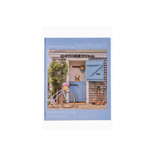 Perfect for puzzle and fine art photography enthusiasts alike, Gray Malin Nantucket 1000 Piece Book Box Puzzle features "Old North Wharf Cottage, Nantucket" from Gray’s best-selling collection, 1000 pieces 