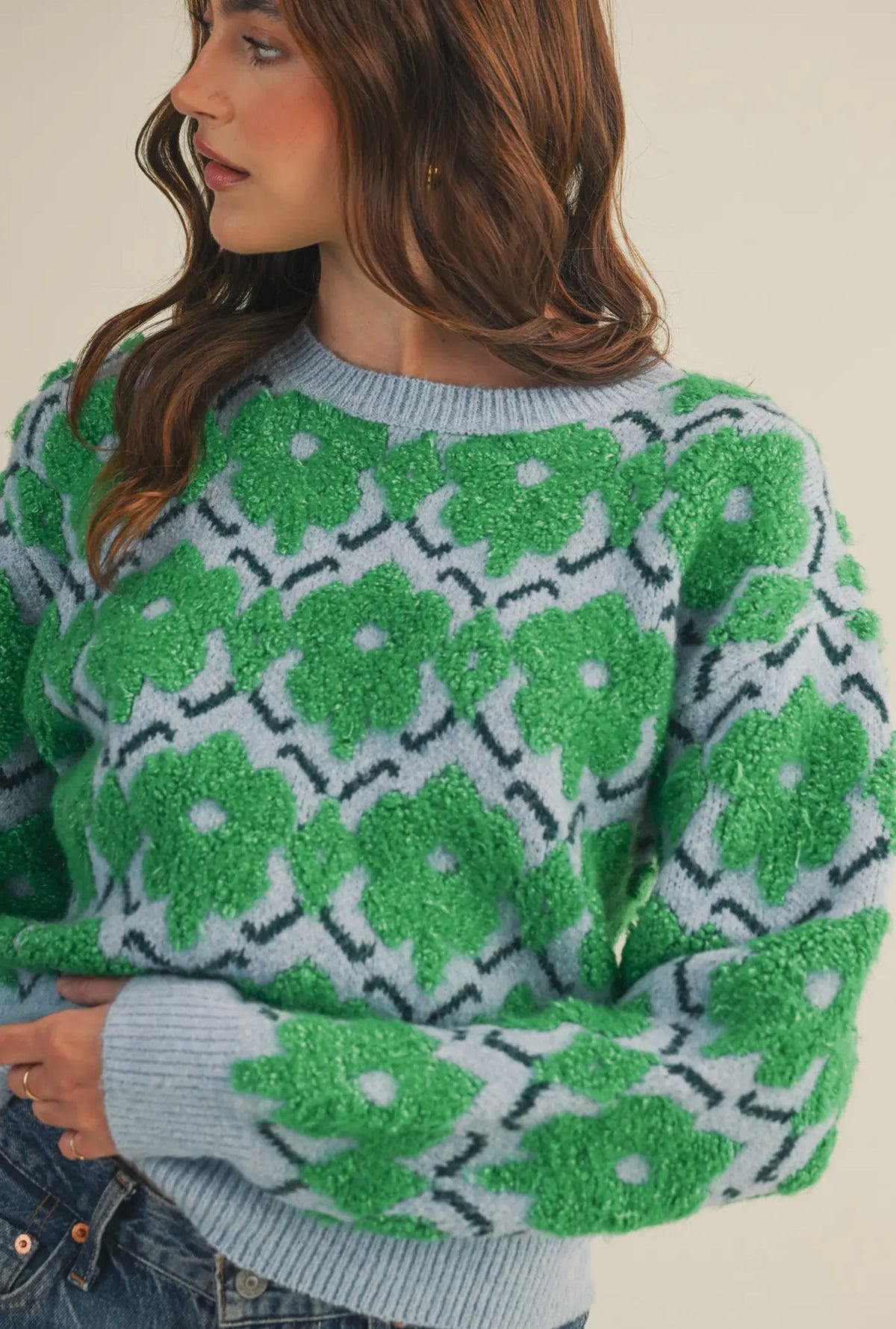This fuzzy textured green and blue floral sweater has a relaxed fit rubbed collar, neckline, cuffs  and hem. 
The warm blue and vibrant green flowers make add the perfect amount of color and fun to fall and winter. 