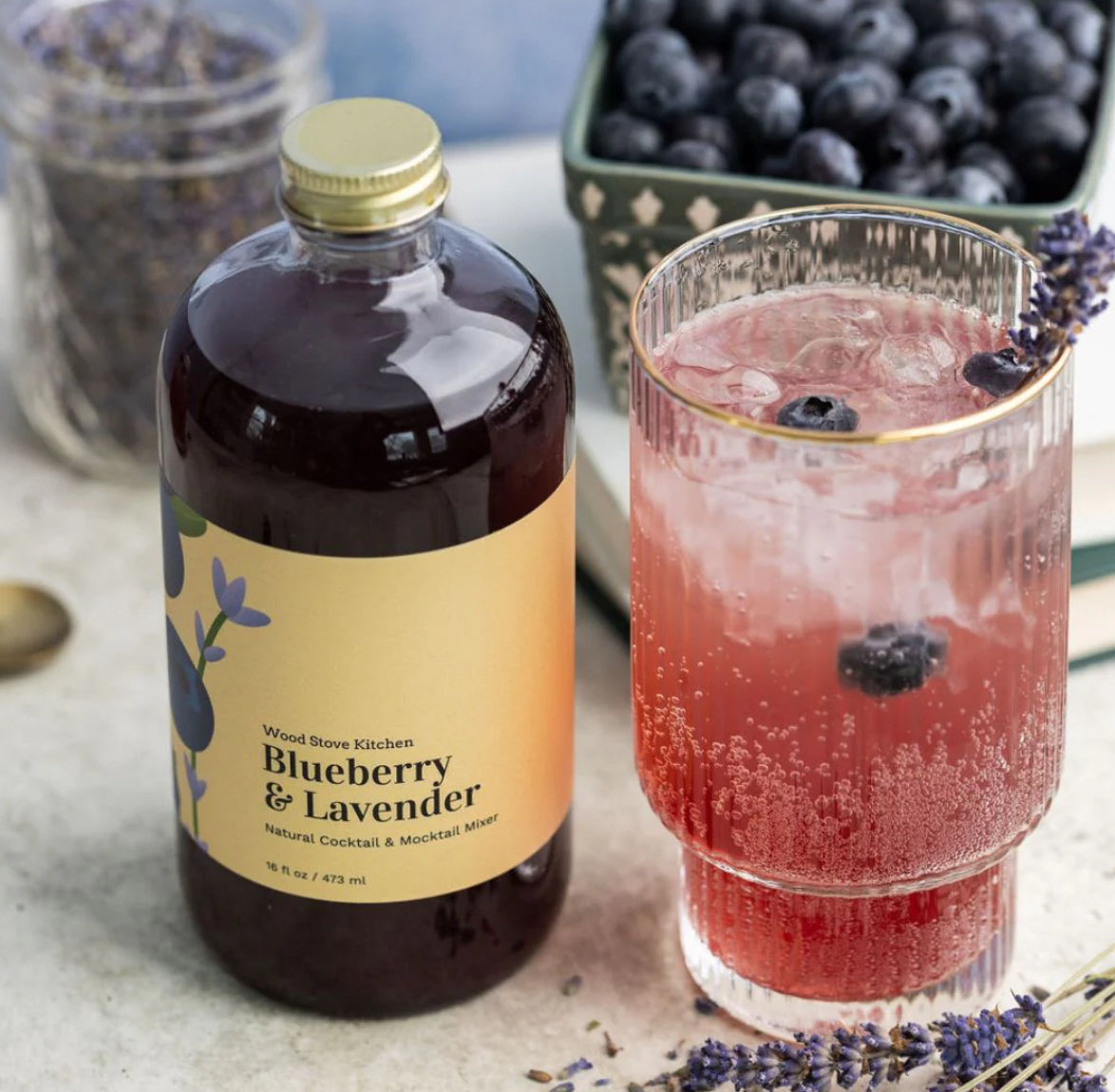 Mixer shown with a made drink and fresh blueberries 