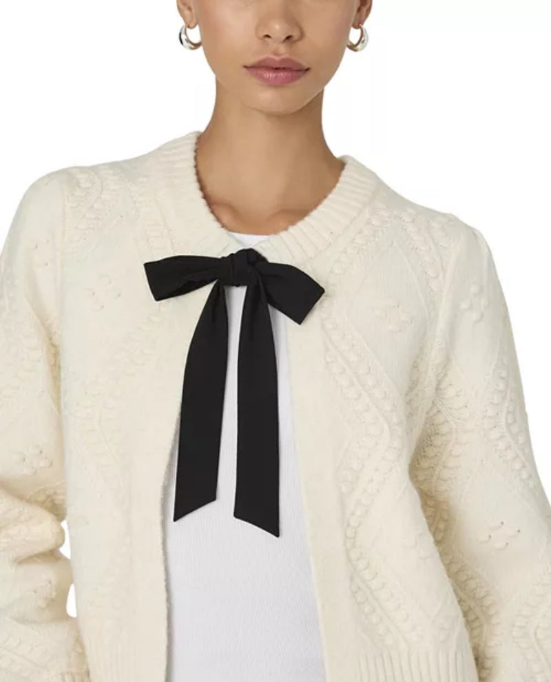Talk about cosy chic, this Kitty Bobble Bow Cardigan is a timelessly sweet style. In a soft, decorative bobble knit, this cute cardi presents a contrasting self-tie ribbon fastening for a feminine touch in monochrome.

The fabric used in this product is partly made from recycled Polyester. Recycled Polyester is made from post consumer products.
* Cardigan
* Fabric: soft knit, bobble stitch, cream + black
* Long balloon sleeves with ribbed cuffs
* Self-tie ribbon fastened neckline
* Ribbed hem
* Regular fit
