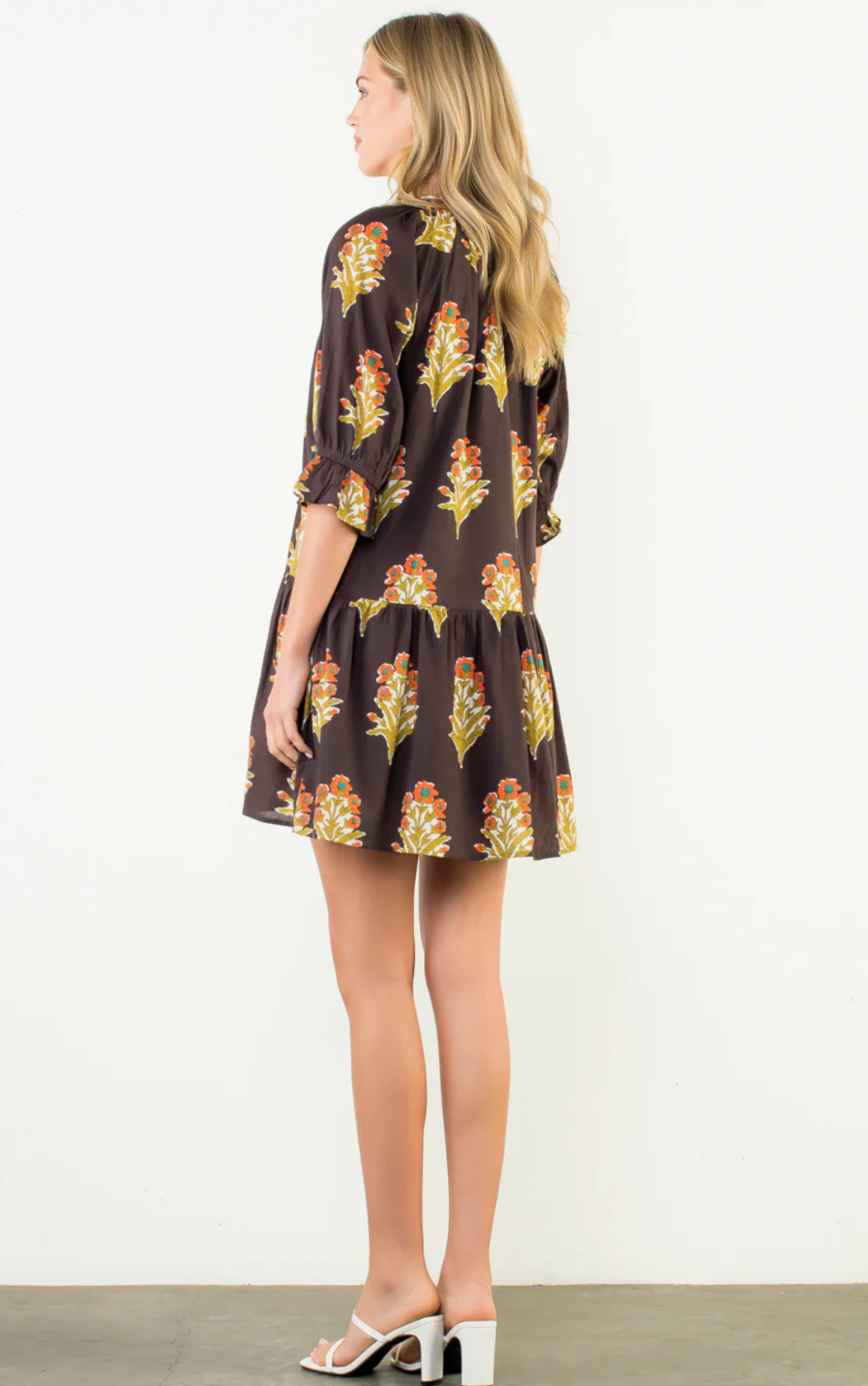 Shown from back. Dark brown base with warm fall tones as pattern