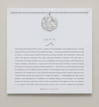 Silver necklace shown on card with saying 