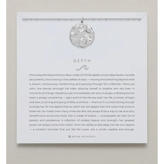 Silver necklace shown on card with saying 