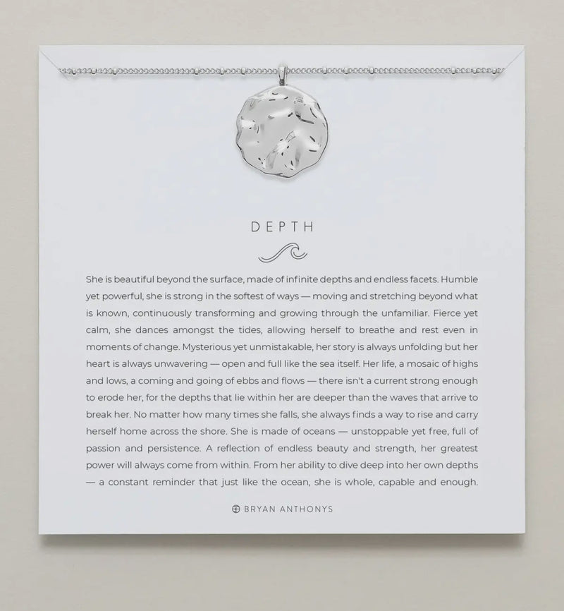 Silver necklace shown on card with saying 