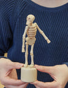 Shown in hands pushing the bottom 