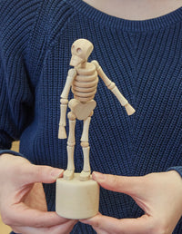 Shown in hands pushing the bottom 