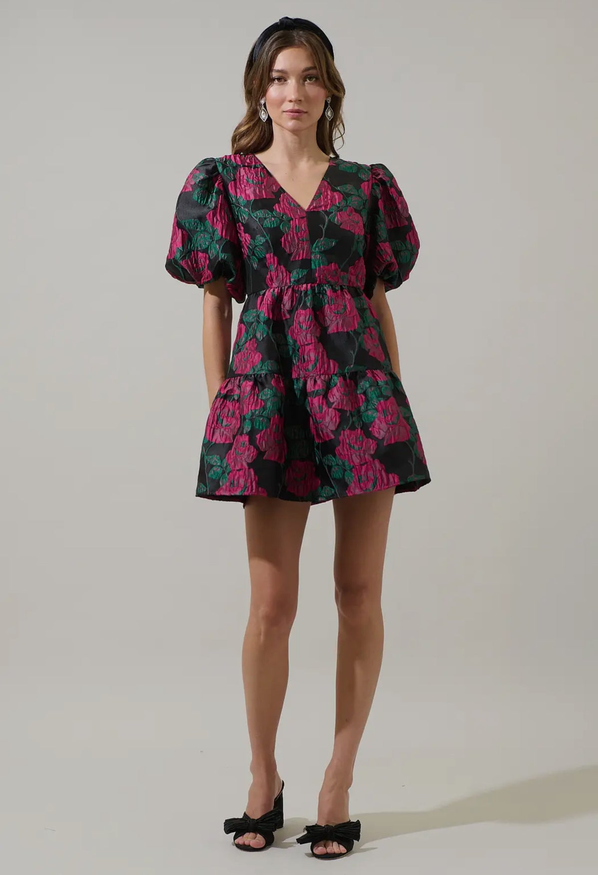 Add a touch of romance to your night with the Farrah Jacquard Floral May Tiered Mini Dress. Floral jacquard fabric shapes this dress with a v-neckline and bubble short sleeves. The open back has a tie string and zipper. Wear it with simple accessories and strappy heels for a finished look.

- Floral
- Jacquard
- V-neck
- Tiered mini 
