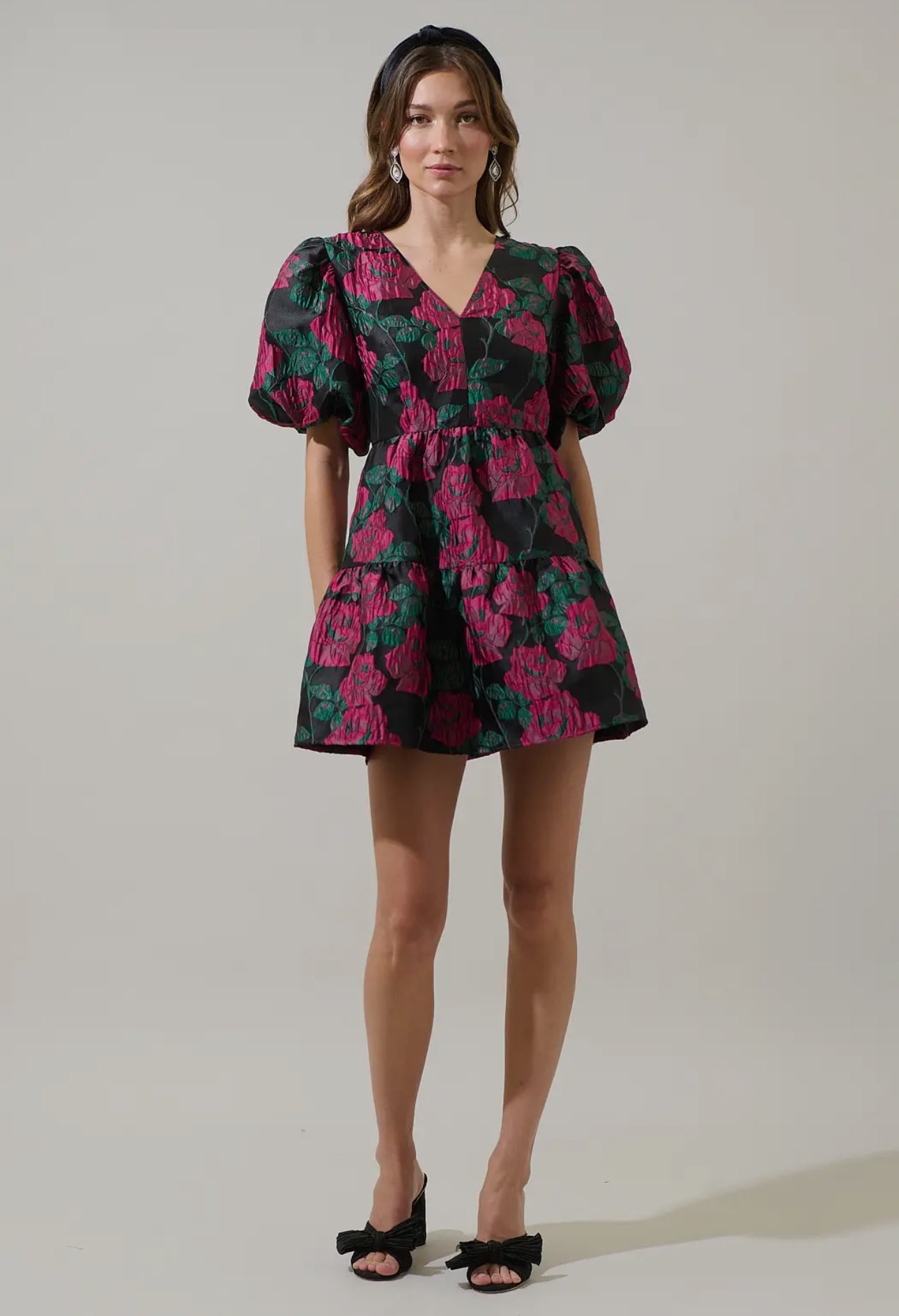 Add a touch of romance to your night with the Farrah Jacquard Floral May Tiered Mini Dress. Floral jacquard fabric shapes this dress with a v-neckline and bubble short sleeves. The open back has a tie string and zipper. Wear it with simple accessories and strappy heels for a finished look.

- Floral
- Jacquard
- V-neck
- Tiered mini 