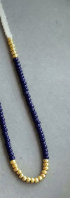 Navy white and gold necklace shown