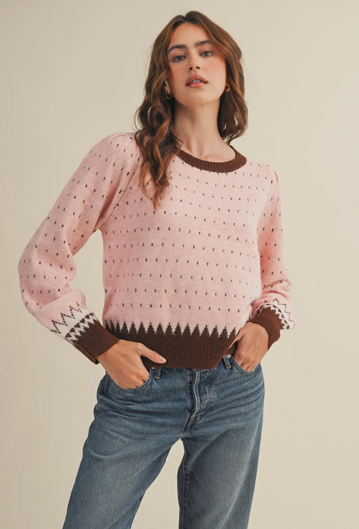 The warm pink and brown hies in this weather are perfect for getting cozy this winter. It also makes a great transition piece. The round neckline in contrasting colors adds to the details of this sweater.  