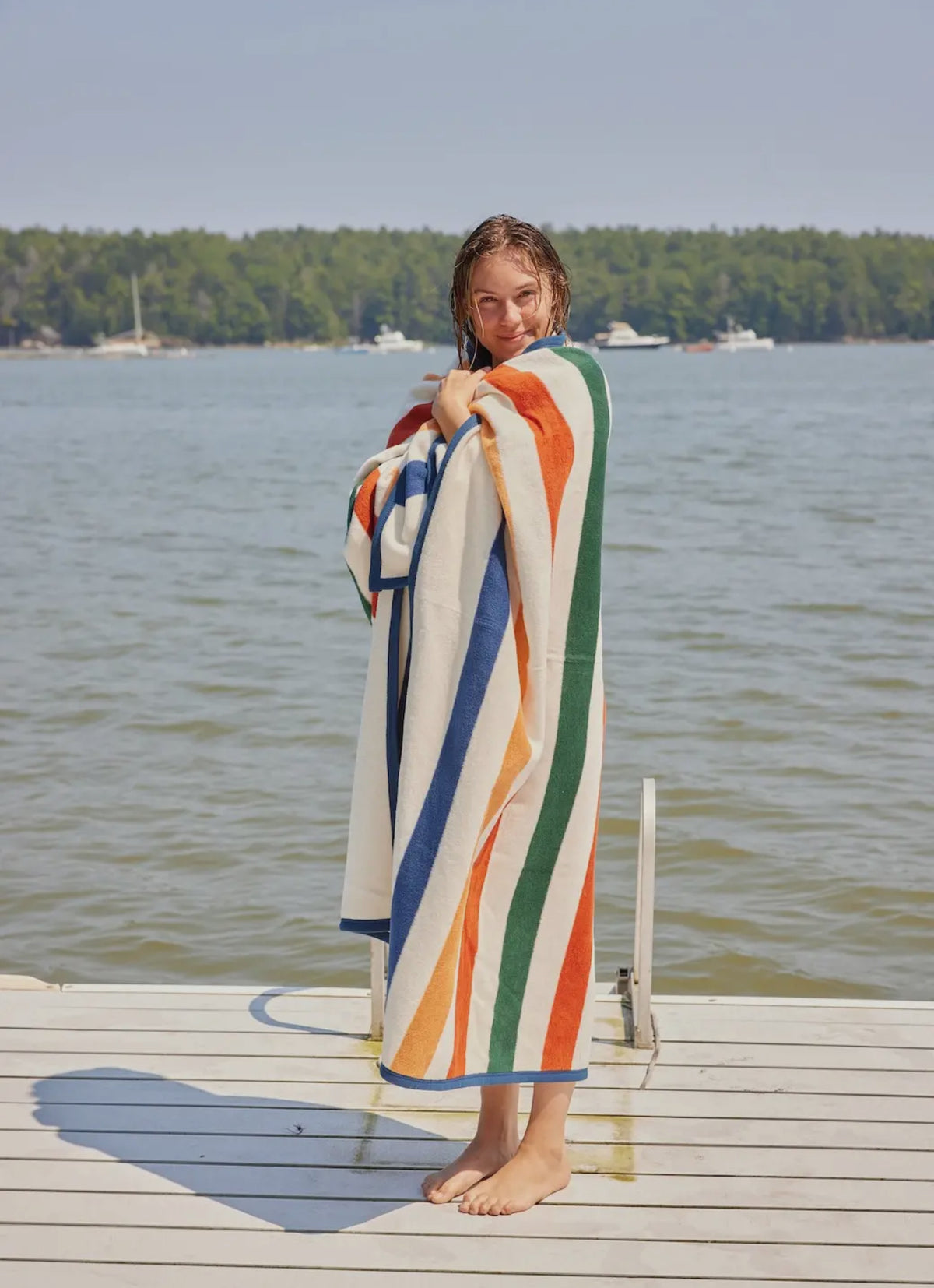 Showing the blanket wrapped on girl on dock 
