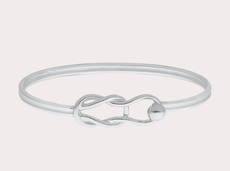 Hand crafted in New England, made of 14k gold and sterling silver.  The Fisherman's Knot is a timeless piece of jewelry that symbolizes eternity and everlasting love. It is great to add to your Cape Cod jewelry collection or wear on it’s own. This classic, simple design will make this bracelet a treasured piece. We are proud to offer authentic the Cape Cod jewelry collection.   Silver shown 