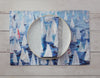 These 100% cotton placemats are reversible. The front side has sailboats all over and the reverse is a dark blue with a line of sailboats. 
Shown with plate and matching napkins 
