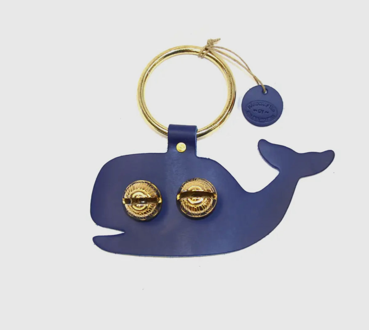 Blue whale shown

Each of these creations are stamped out of authentic leather. We then use an old-fashioned, foot powered, riveter to attach the 2 1/2” ring.

After the ring is attached, we add two of the popular #1 bells, with easy to remove, patented design pins, for quick cleansing. Each product has a hand punched and stamped leather tag affixed to the ring.