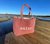 This top selling bag is perfect for days on the beach, boat or running errands.  

Durable cotton canvas bag imprinted with the words, "SALTY". Thick & cushioned 12" Shoulder length handles

Nantucket red shown