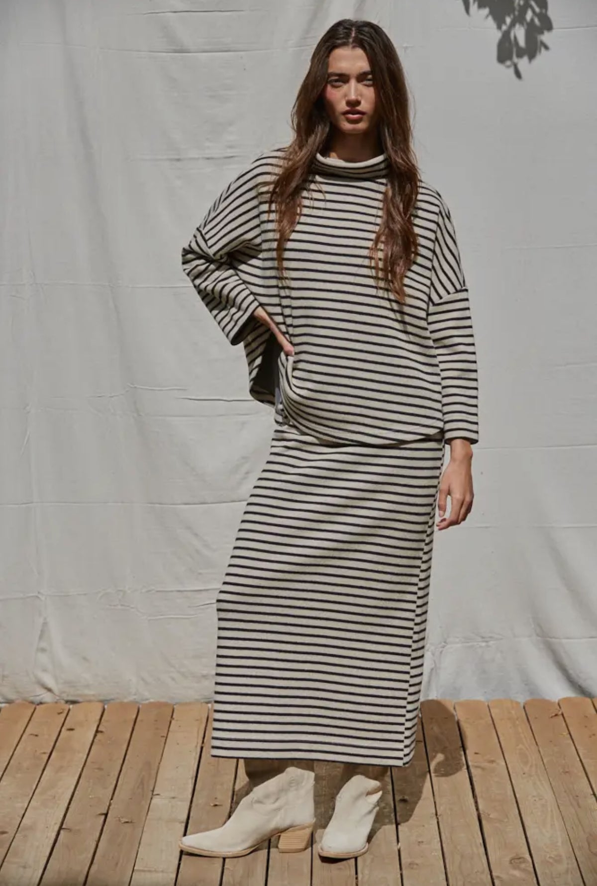 This skirt was selling right out the box. Pair with the matching top to complete the set or a favorite from your closet.   Off white and black stripe 