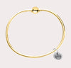 The original design of the Cape Cod Jewelry®️ line, with a sterling silver bangle and single ball available in sterling silver, 14k yellow gold. 