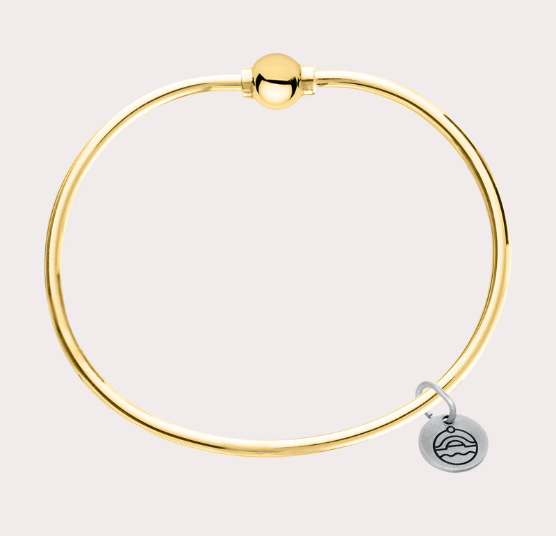 The original design of the Cape Cod Jewelry®️ line, with a sterling silver bangle and single ball available in sterling silver, 14k yellow gold. 