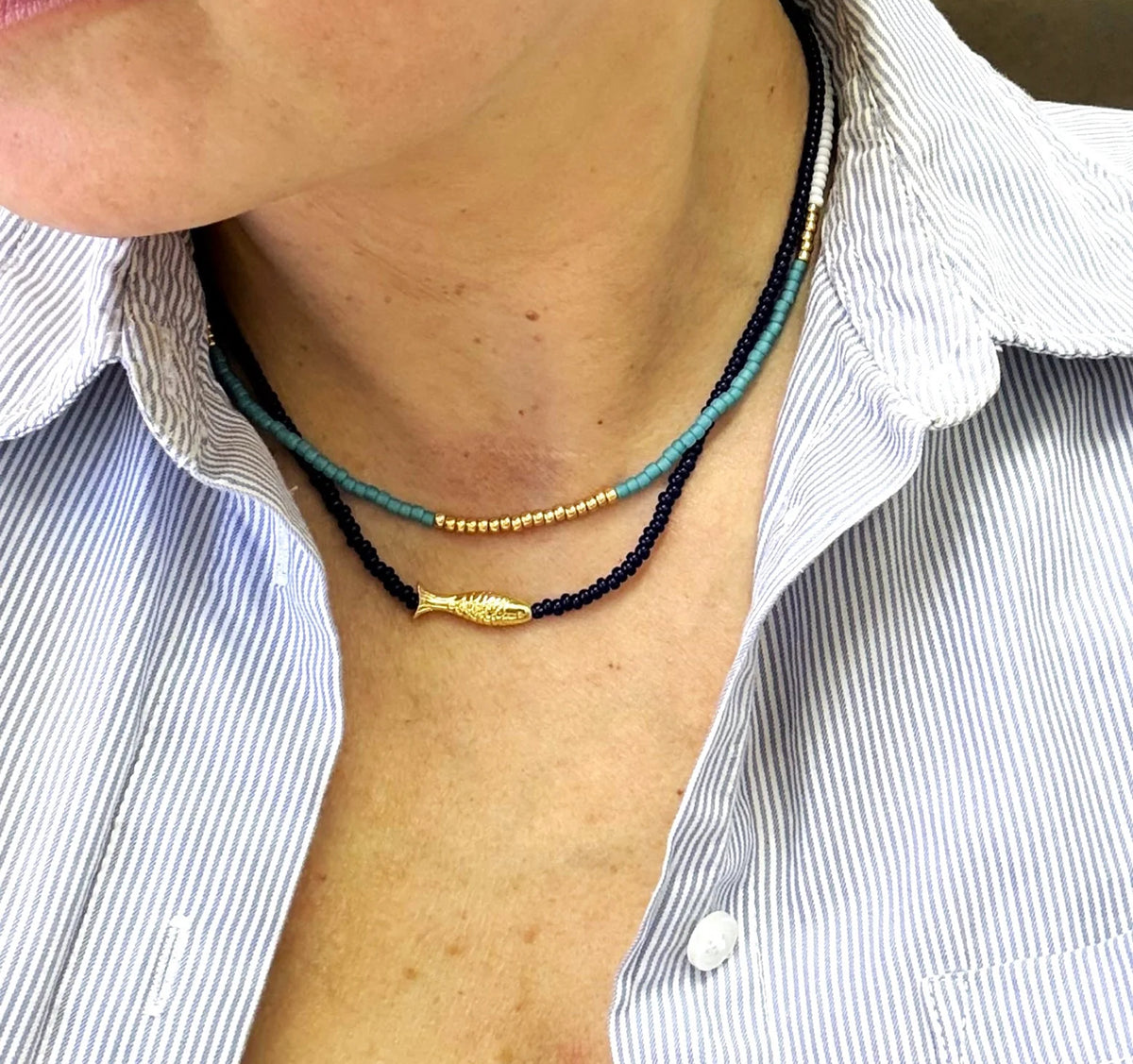 Turquoise necklace shown with fish necklace 