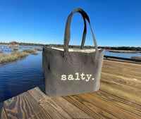 This top selling bag is perfect for days on the beach, boat or running errands.  

Durable cotton canvas bag imprinted with the words, "SALTY". Thick & cushioned 12" Shoulder length handles
Dark grey shown 