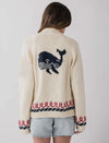 This cozy knit cardigan gives the effortless coastal energy and is perfect for cooler days, chilly nights by the bonfire and endless summer vibes. 

Cream sweater with large blue whale  on back and red and blue knit around the waist and wrists. 