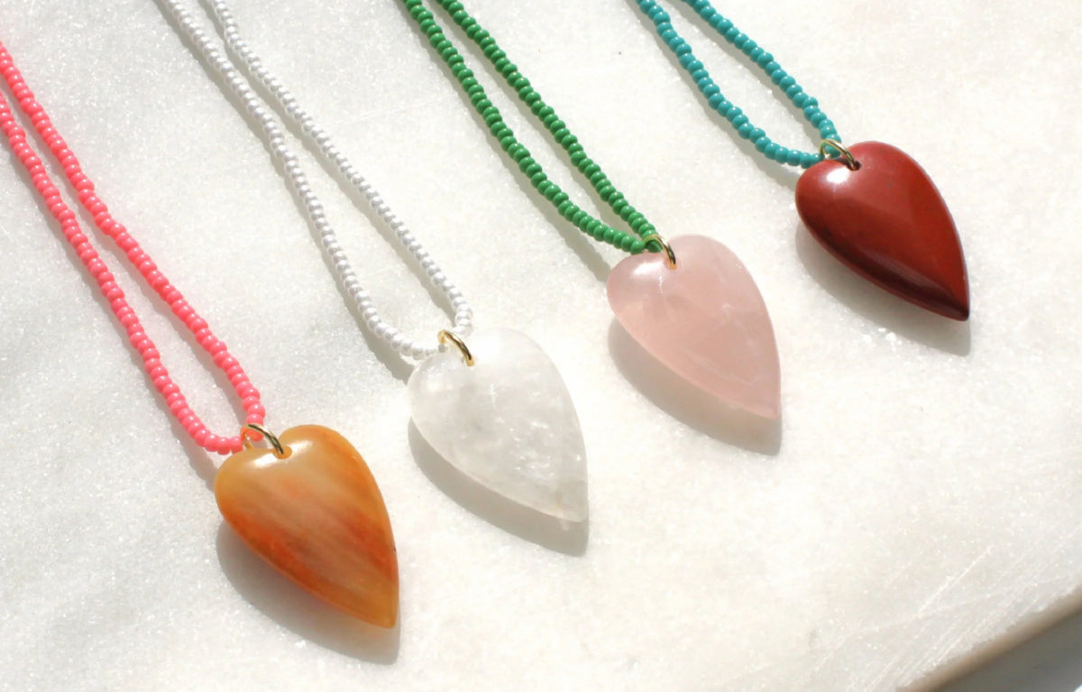 Fall in love with our heart-shaped gemstone necklaces. Made with hand strung beaded necklaces, these trendy pieces are perfect for layering or wearing solo. A must-have for lovers of statement jewelry and romantic accessories. Perfect for everyday wear or as a gift!
_______________
DETAILS
•Gemstone pendant in your choice of stone
•Hand strung beaded necklace with tiny glass seed beads

Made in USA 