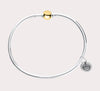 The original design of the Cape Cod Jewelry®️ line, with a sterling silver bangle and single ball available in sterling silver, 14k yellow gold. Gold and silver shown 