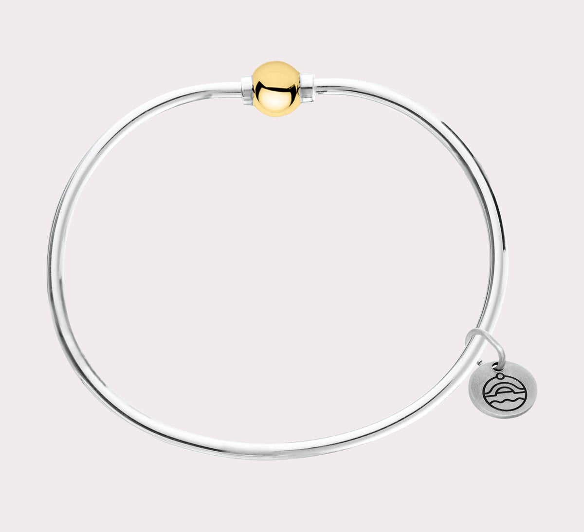 The original design of the Cape Cod Jewelry®️ line, with a sterling silver bangle and single ball available in sterling silver, 14k yellow gold. Gold and silver shown 