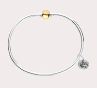 The original design of the Cape Cod Jewelry®️ line, with a sterling silver bangle and single ball available in sterling silver, 14k yellow gold. Gold and silver shown 