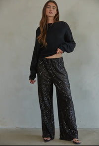 Disco Vibes! Turn heads with these twinkling sequin flashback pants that exude disco vibes. Featuring all over black sequin these pants are sure to turn heads! 

This item is new, buy now before it's too late! 

*Eligible for returns. If you are not completely satisfied, you may return your purchase for a credit or refund. Items that cannot be returned are marked as Final Sale. See Details.

Details:

Sequin wide leg pants
Elastic waist band
Polyester lining
Fabric: 95% Polyester, 5% Spandex
Dry clean only 