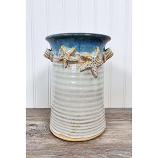 Organize your kitchen or dining space with our Wine Bottle Holder / Utensil Holder, designed to elegantly store both utensils and wine accessories. 
The Dimensions of this item are approximately 6x6x9.

Each piece of pottery is crafted with love. There may be slight variations in sizes and glazes making them truly one-of-a-kind.