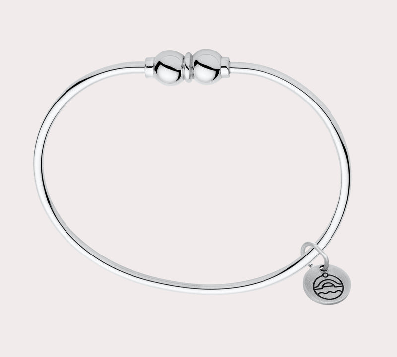 Add to your original design collection of the Cape Cod Jewelry®️ with a sterling silver bangle and double  ball available in sterling silver, 14k yellow gold. Silver shown 