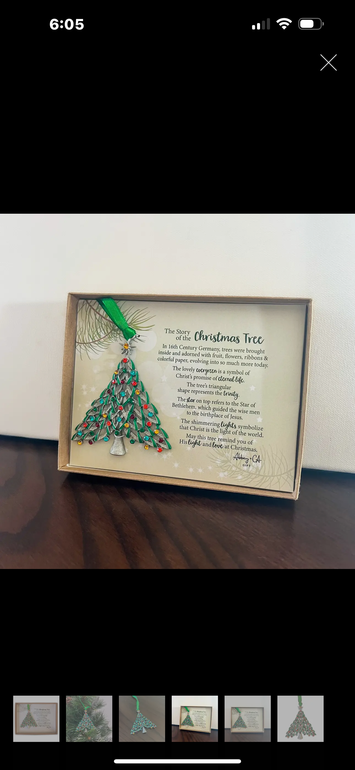 Tree shaped ornament adorned with multi-colored stones and shiny green epoxy
Metal with silver enamel finish
Ribbon for hanging
Measures 2 ¾”W x 3 ¼”H
Gift Boxed with story card

Story card reads:
Story of the Christmas Tree
In 16th Century Germany, trees were brought inside and adorned with fruit, flowers, ribbons & colorful paper, evolving into so much more today.
The lovely evergreen is a symbol of Christ’s promise of eternal life.
The tree’s triangular shape represents the trinity.
The star on top refer